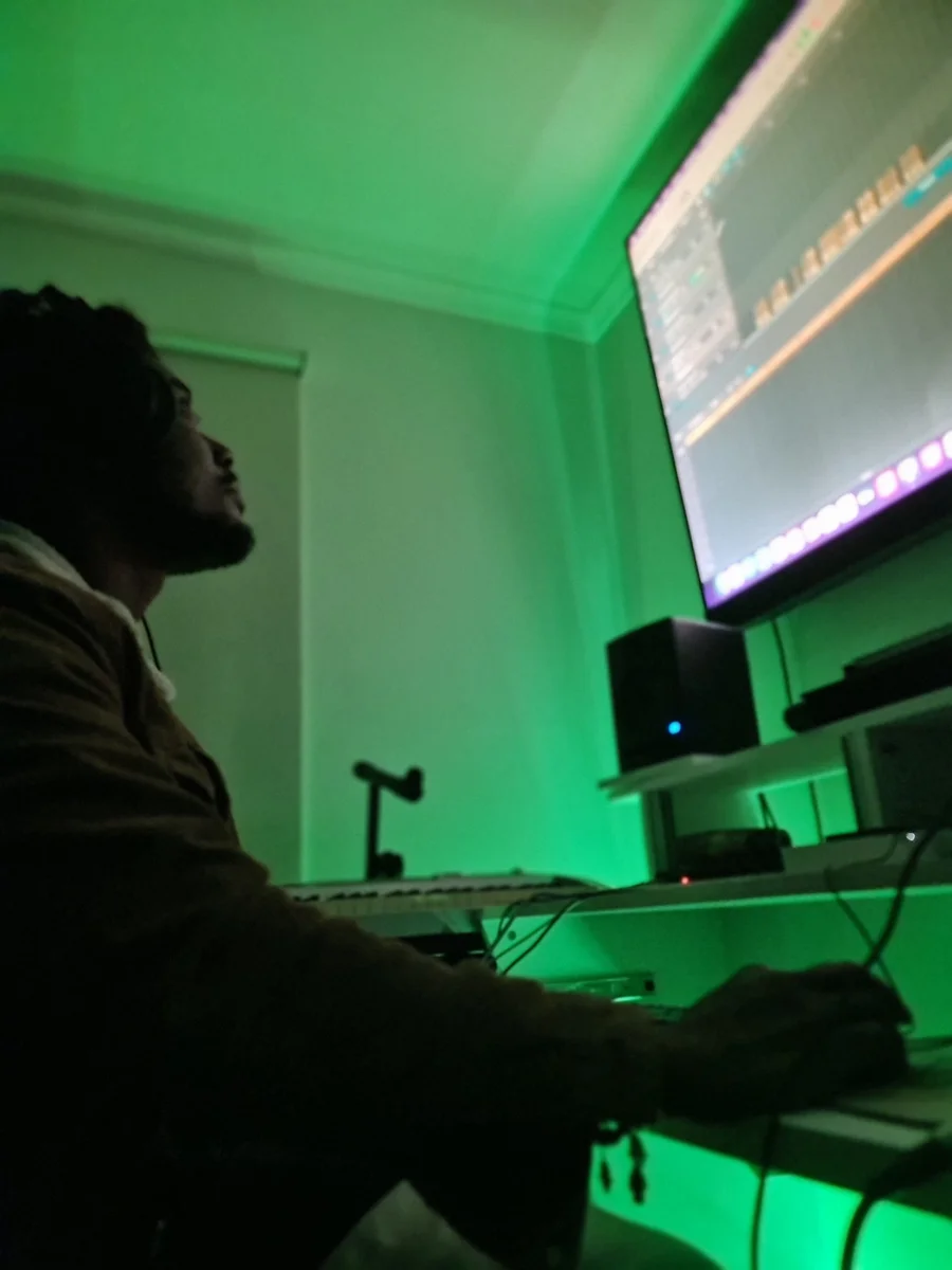 Producer working on a track at a studio computer